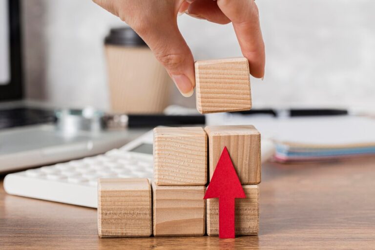 hand-placing-wooden-block-represent-growth_23-2148780590